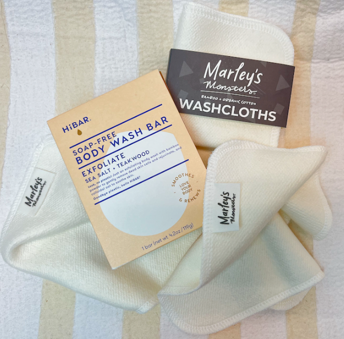 Marley's Monsters washcloths and hibar body wash bar on a striped background