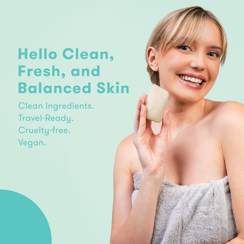 Woman holding face wash bar with text about skincare products on a light green background. Hello clean, fresh and balanced skin. Clean ingredients. Travel-ready. Cruelty-free. Vegan.