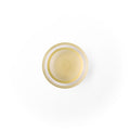 Coconut Oil in a glass dish. It is an ivory colored liquid.