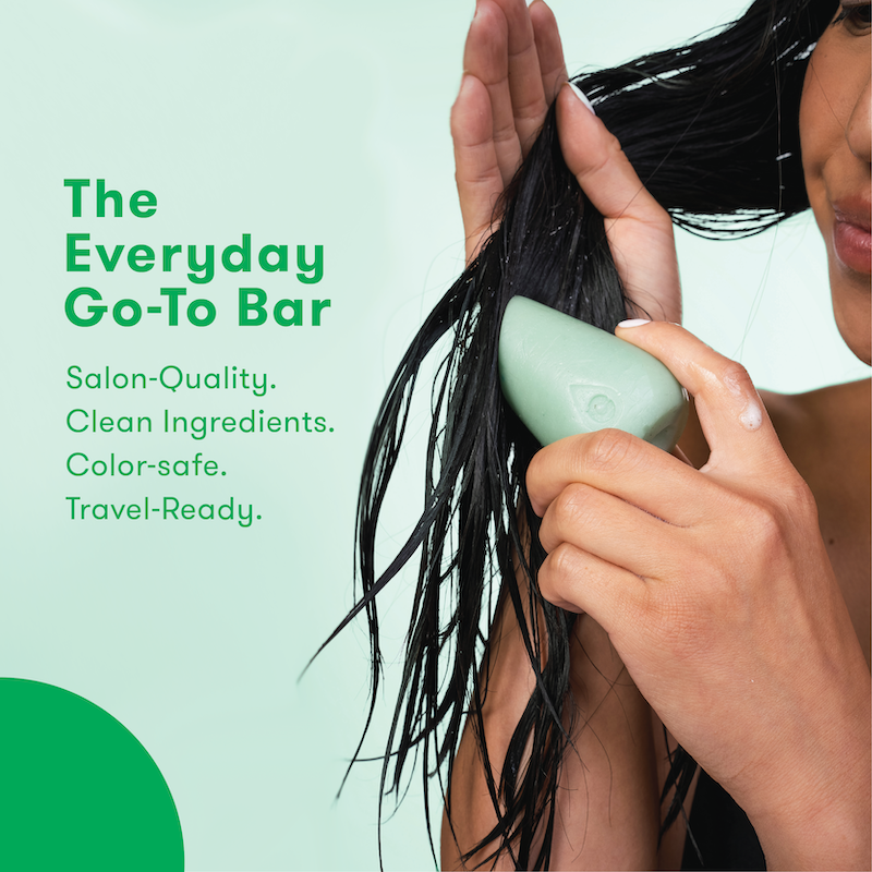 Picture of a person applying HiBAR Conditioner Bar directly to hair strands with information about the product: The Everyday Go-To Bar. Salon-Quality. Clean formula. Color safe. Travel-ready.