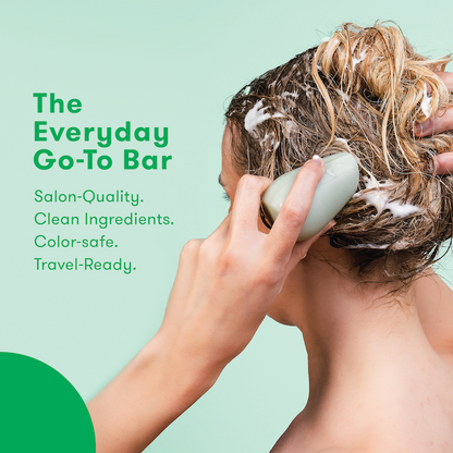 Picture of a person applying HiBAR Shampoo Bar directly to hair strands with information about the product: The Everyday Go-To Bar. Salon-Quality. Clean formula. Color safe. Travel-ready. 