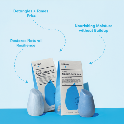 HIBAR solid shampoo and conditioner bars with packaging on a blue background and product call-outs: deranges + tames frizz. Restores natural resilience. Nourishing moisture without buildup.