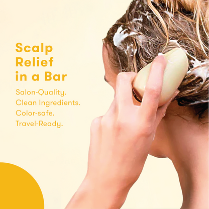 Person using shampoo bar to wash their hair with the words: Scalp Relief in a Bar. Salon-quality. Clean formula. Color-safe. Travel-ready.