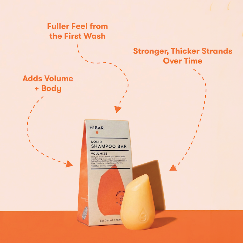HIBAR solid shampoo bars  with packaging on a peach background with product highlights: Fuller feel from the first wash. More Volume + Body. Stronger, thicker strands over time. 