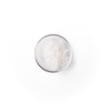 glyceryl_stearate in a glass dish. It is a white colored powder.