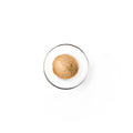 olive seed powder in a glass dish. It is brownish powder.