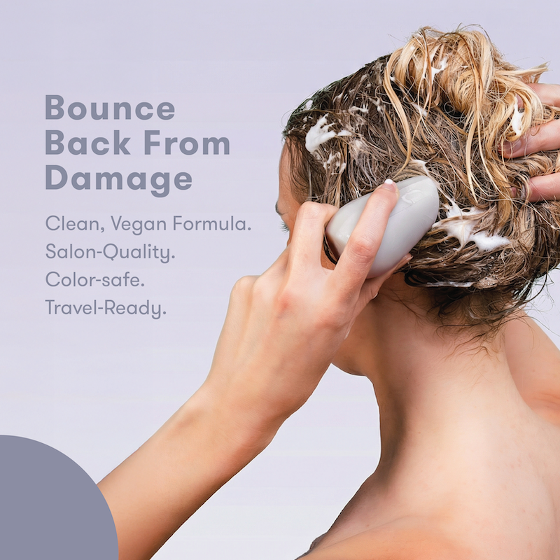 Person holding HiBAR Shampoo Bar with text about product benefits. Bounce Back From Damage. Salon-quality. Clean, vegan Formula. Color-safe. Travel-Ready.