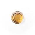 white willow bark extract in a glass dish. It is a brown colored liquid.